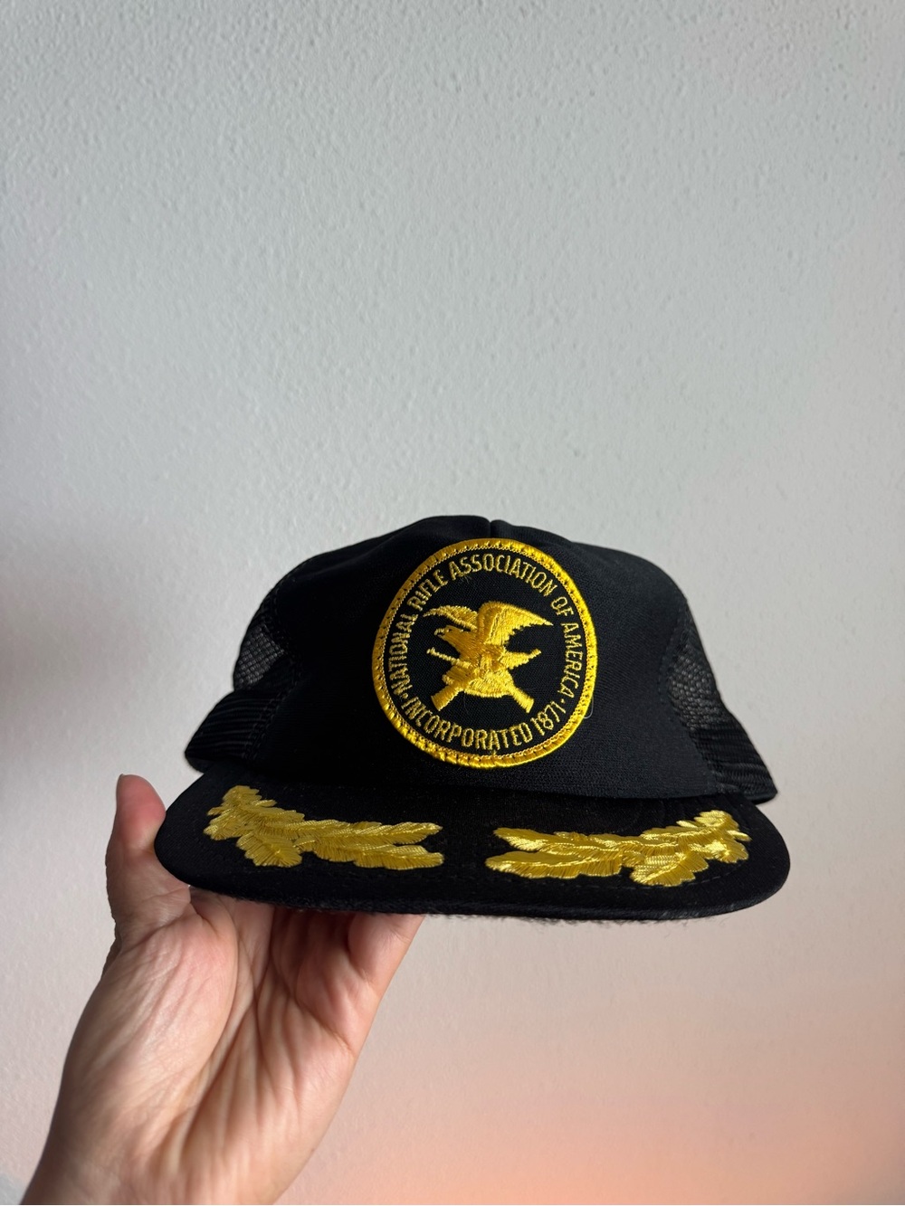 Black Trucker Cap with Gold Embroidered NRA Patch